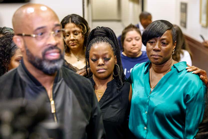 Crystal Mason (right) listens as her pastor Frederick Haynes (left) speaks with reporters...