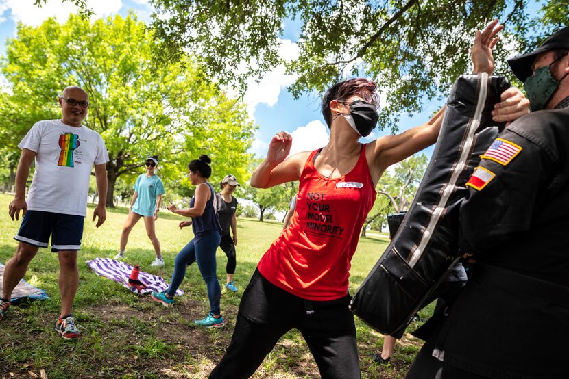 Lilly Lin,  a member of Dallas Women of Asian Descent, practiced palm strikes on a pad held...