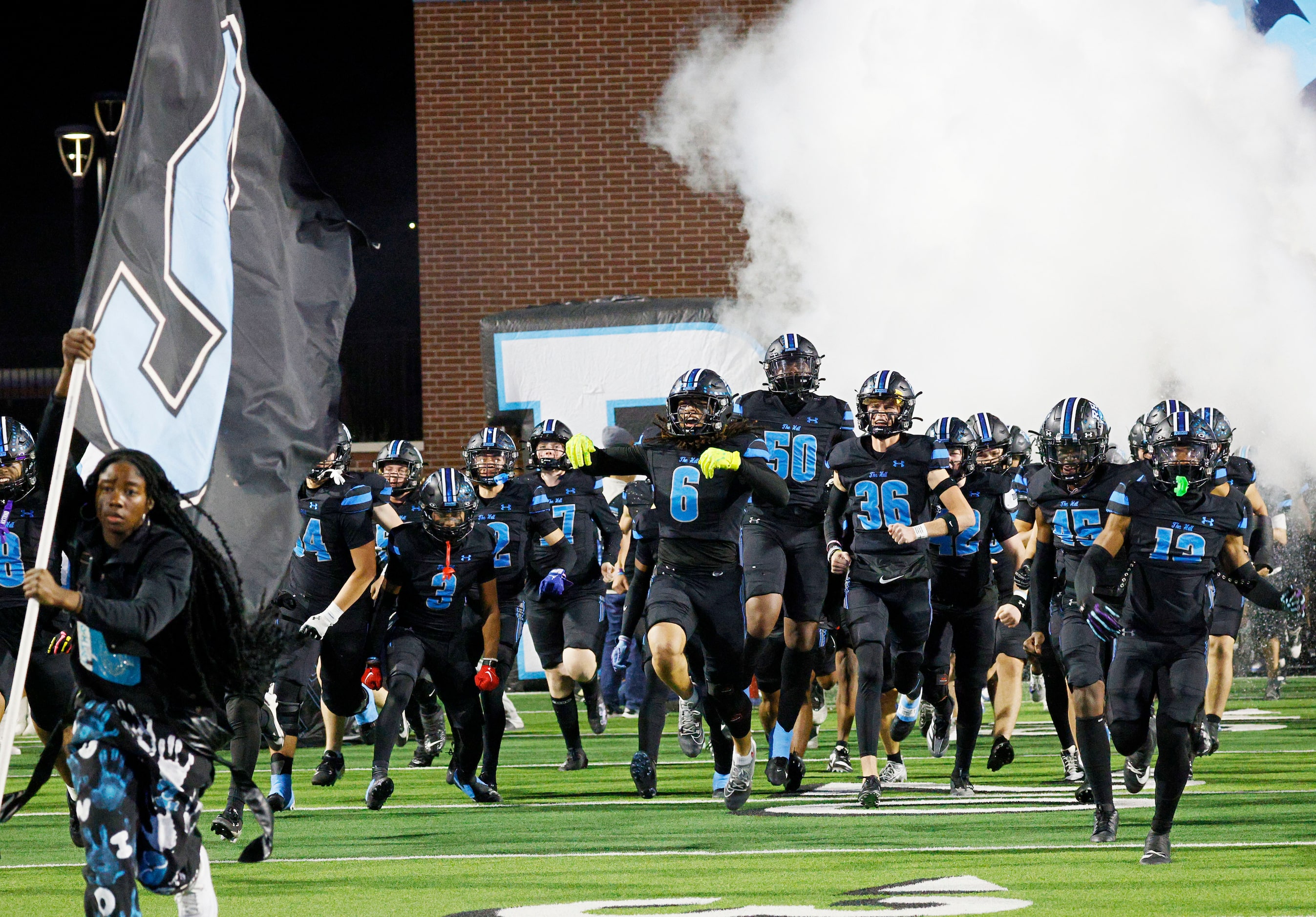 Rock Hill’s players run onto the field before a high school football game against Hebron at...