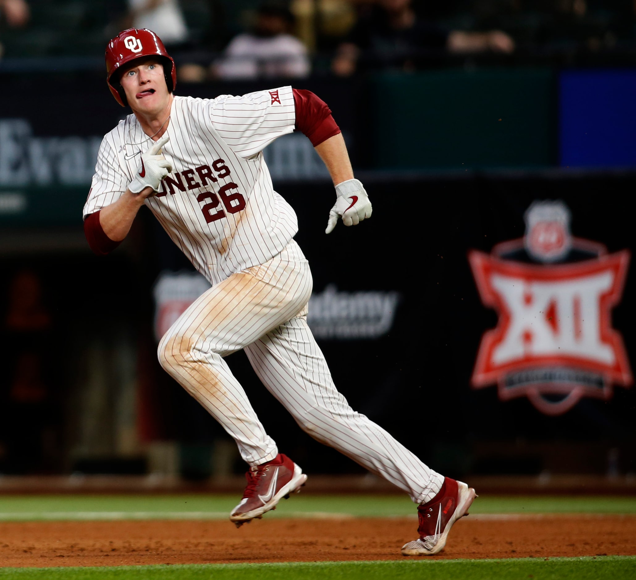 Oklahoma Sooners first baseman Blake Robertson (26) watches a long drive by teammate Tanner...