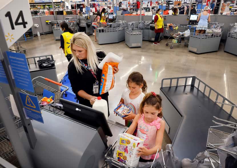 Breanna Hale of Frisco receives some help from her daughters, Burklee (center) and Ellasyn,...