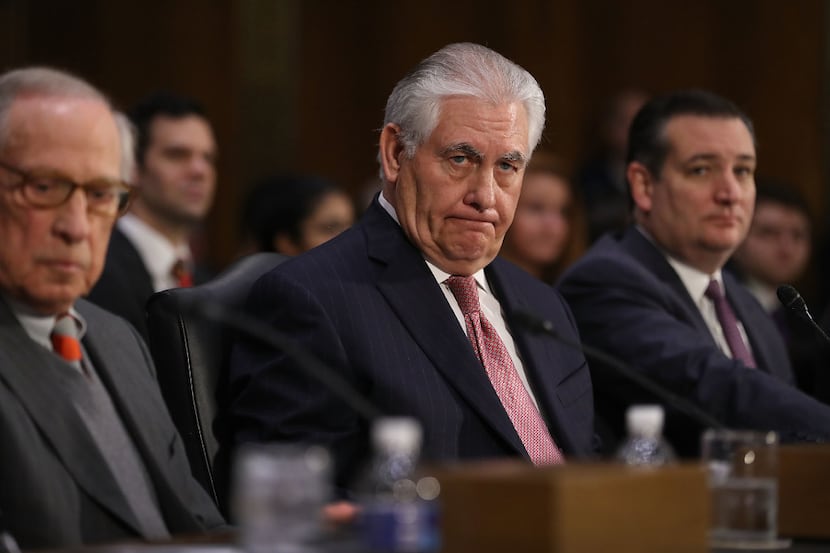 Rex Tillerson awaits his confirmation hearing for secretary of state, flanked by Sen. Ted...