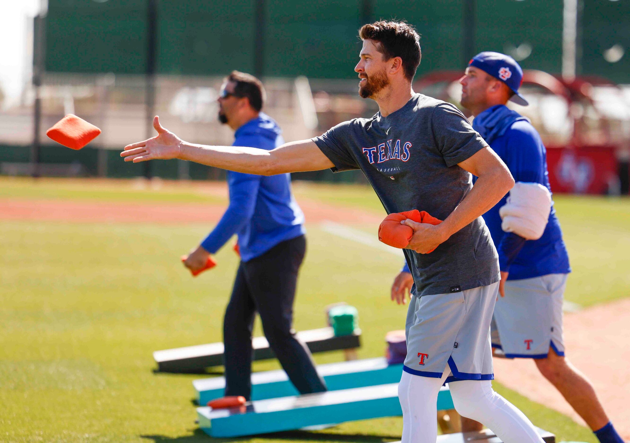 Texas Rangers pitcher Jacob deGrom plays cornhole after spring training workout at the...