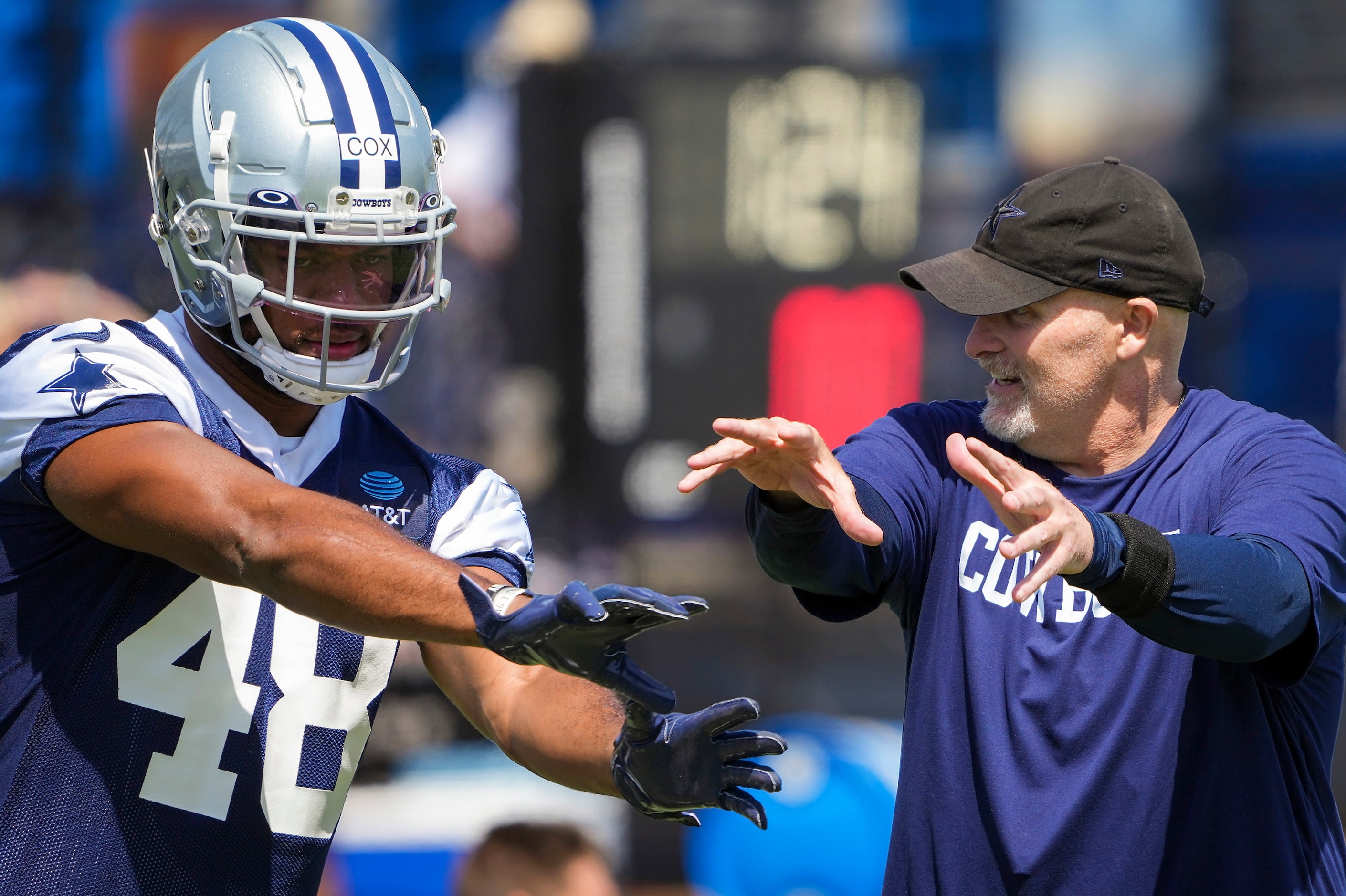 Dallas Cowboys defensive coordinator Dan Quinn works with linebacker Jabril Cox (48) during...