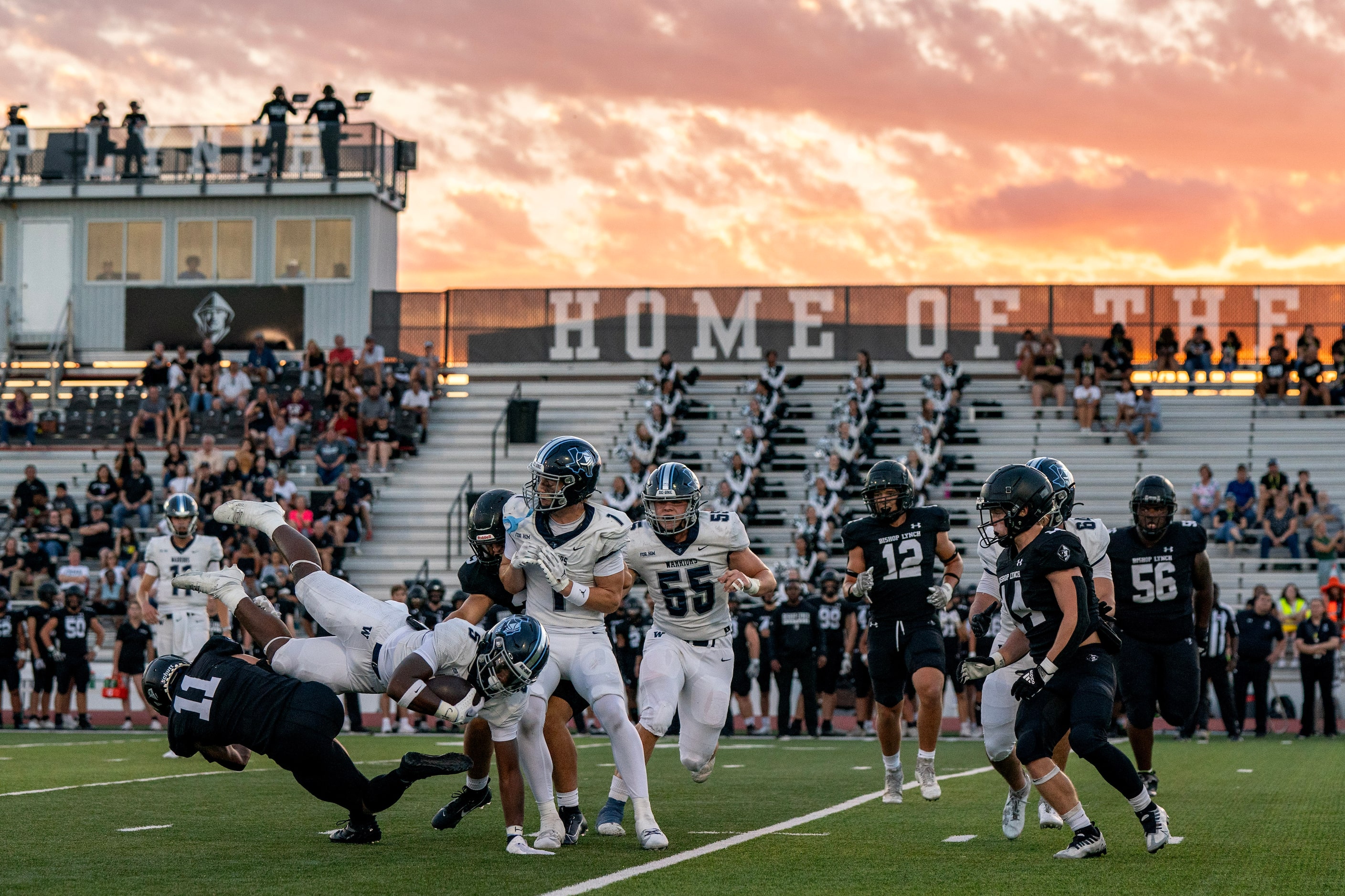 Argyle Liberty Christian junior running back Chase Garnett (5) is upended by Bishop Lynch...