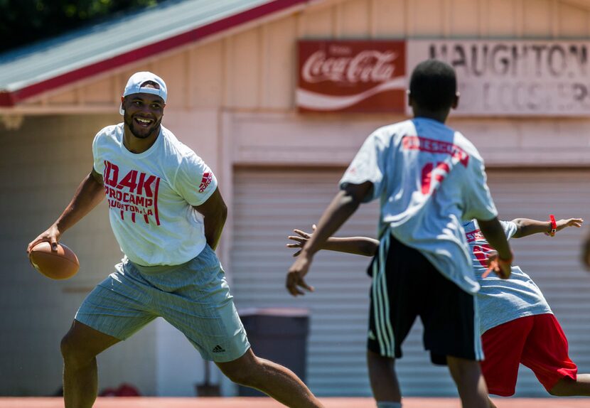 Dallas Cowboys quarterback Dak Prescott plays football with campers at his Dak Prescott...