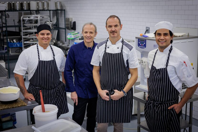 Carlo Gattini (third from left), owner of Botolino Gelato Artigianale, stands with gelato...