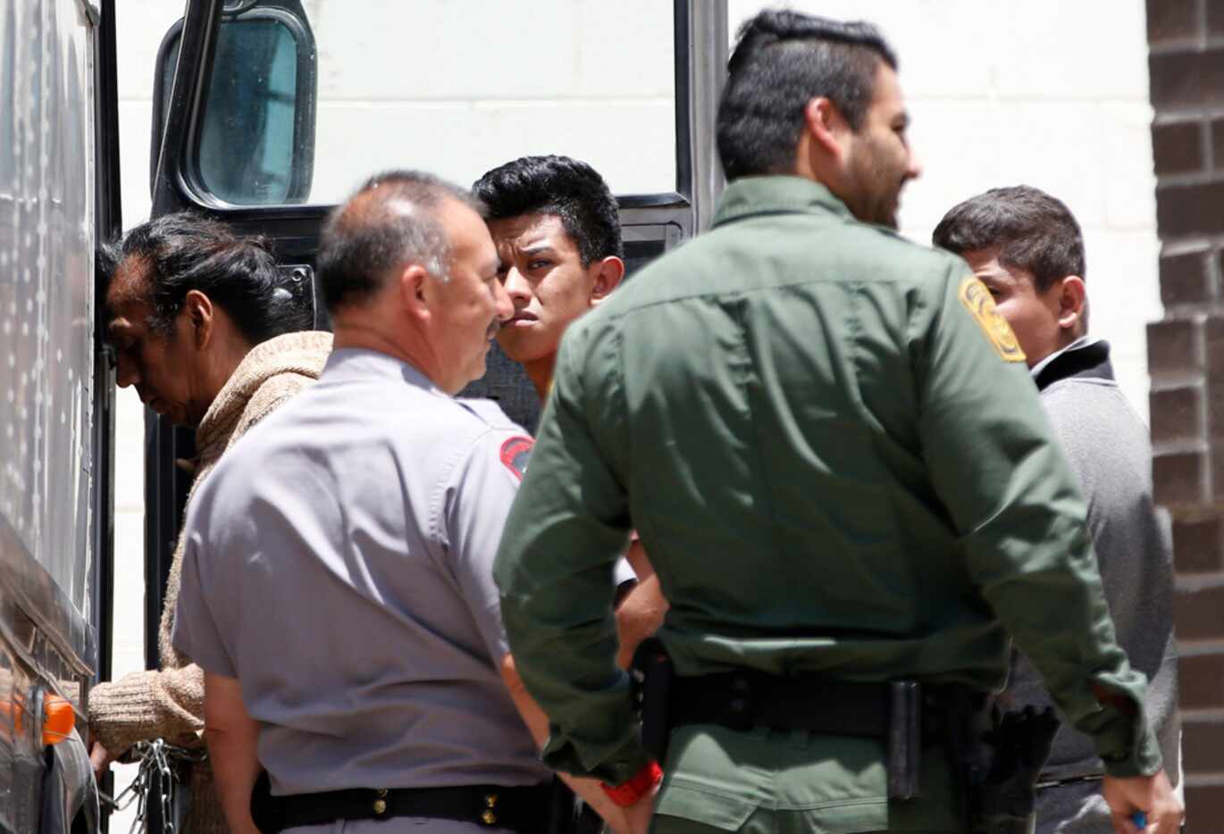Detained immigrants load into buses at the federal courthouse in McAllen, Texas, on June 11,...