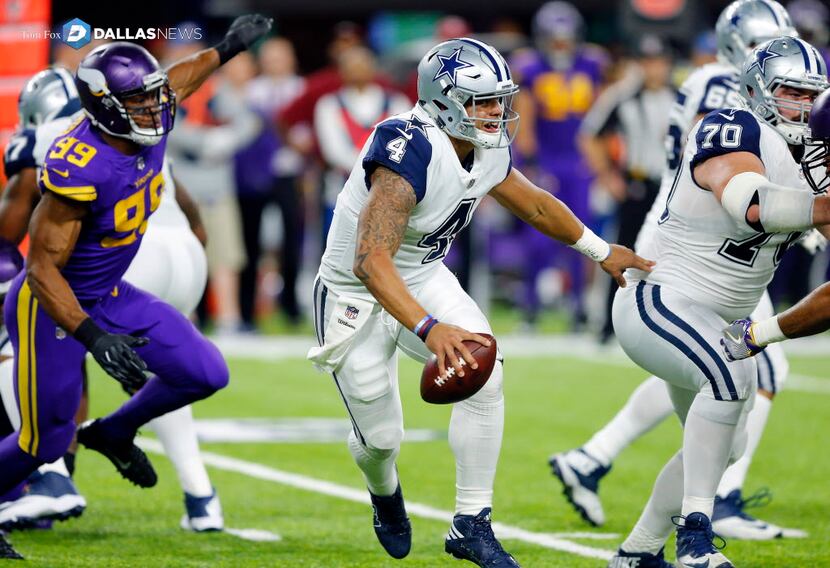 Dallas Cowboys quarterback Dak Prescott (4) is forced out of the pocket by the Minnesota...