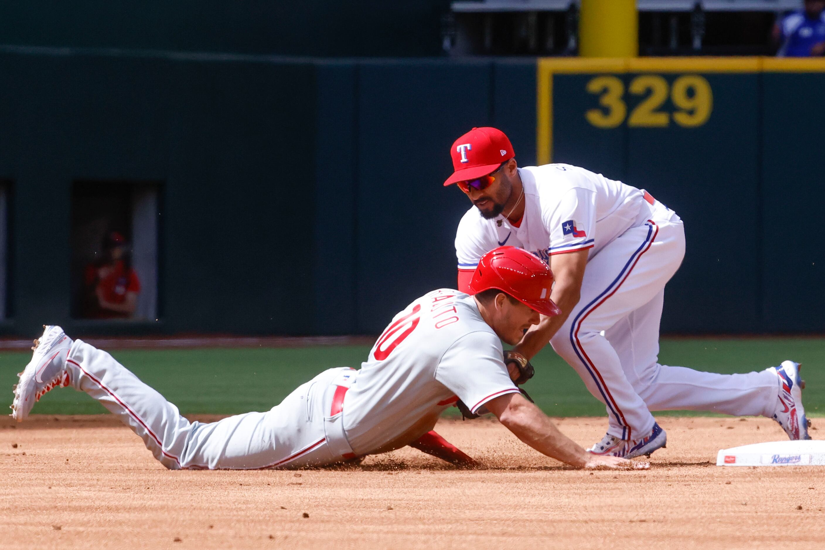 Texas Rangers second baseman Marcus Semien (right) tags out Philadelphia Phillies catcher...