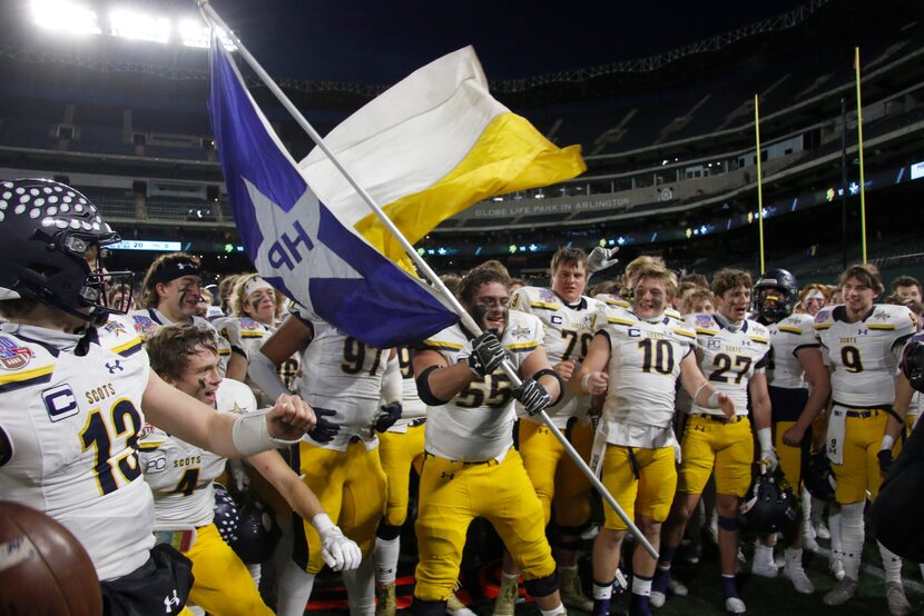 Highland Park offensive lineman Sam Morse (55) handles the flag waving duty as the Scots...