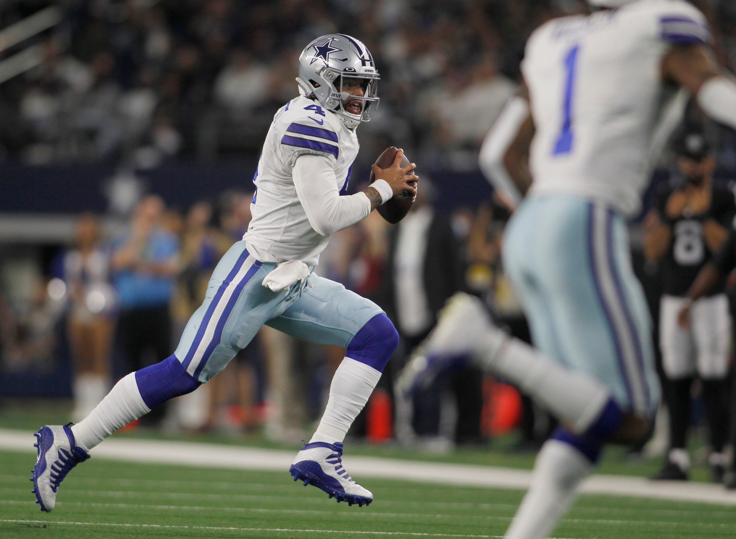 Dallas Cowboys quarterback Dak Prescott (4) rushes during the 2nd quarter of their game...