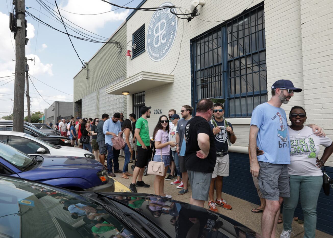 Customers wait in line to celebrate the new "beer to go" state law at Peticolas Brewing...
