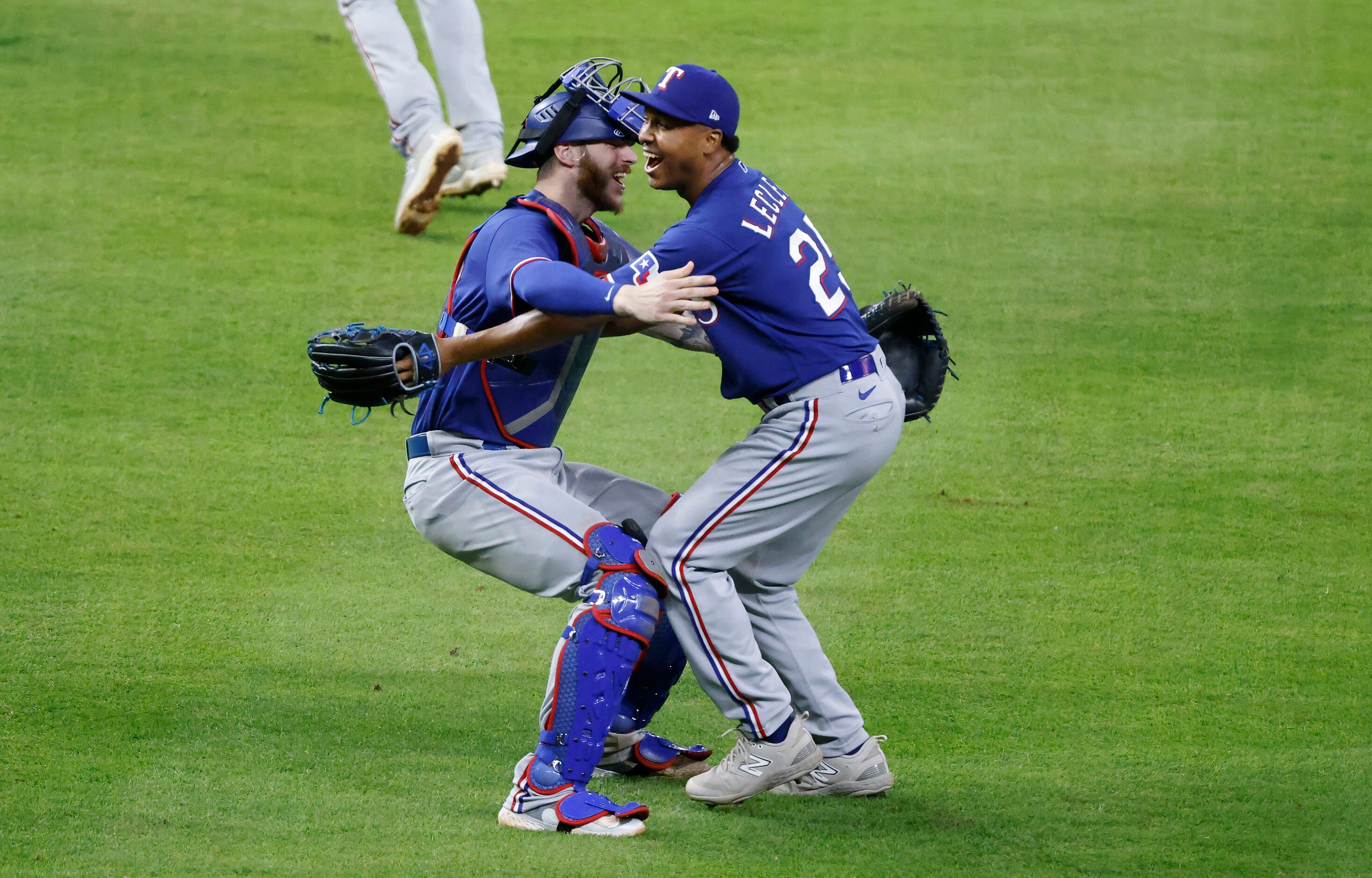 Texas Rangers relief pitcher Jose Leclerc (right) and catcher Jonah Heim Hugh one another...