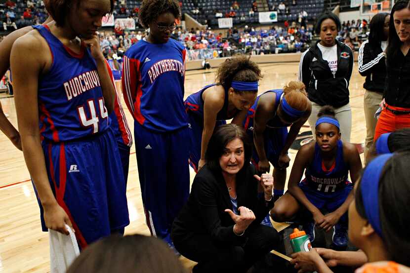 Duncanville head coach Cathy Self-Morgan (center) talks with players on a time out during...
