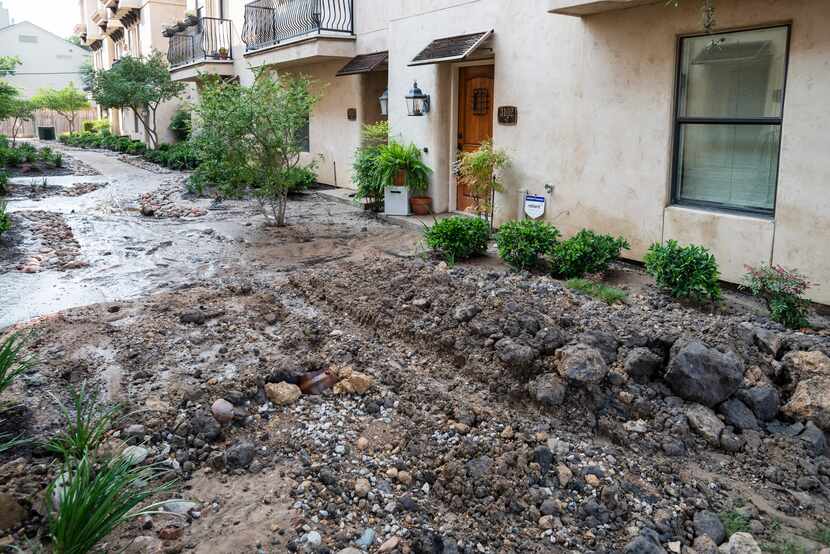 The flooding left a sludgy mix of mud and asphalt along parts of Ross, including a courtyard...