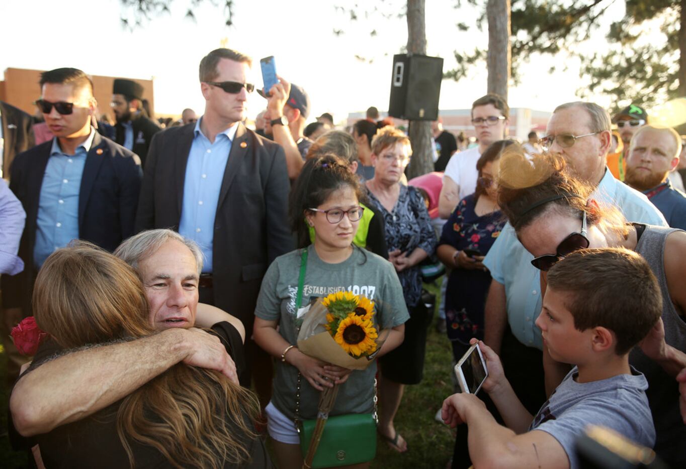 Gov. Greg Abbott hugs a Santa Fe student at Friday night's vigil. 