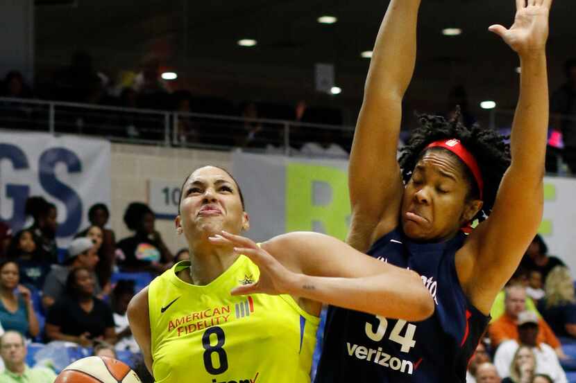 Dallas Wings center Liz Cambage (8) drives to the basket past the defense of Washington...