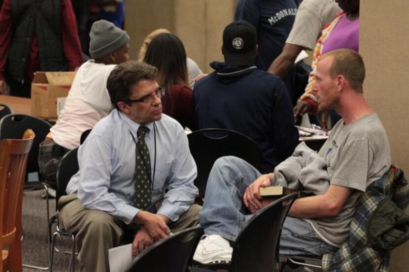 Val Armstrong speaks with one of the library’s homeless customers about why the library is...