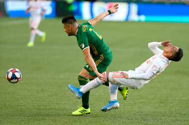 Atlanta United's Ezequiel Barco, right, is fouled by Portland Timbers' Jorge Moreia during...