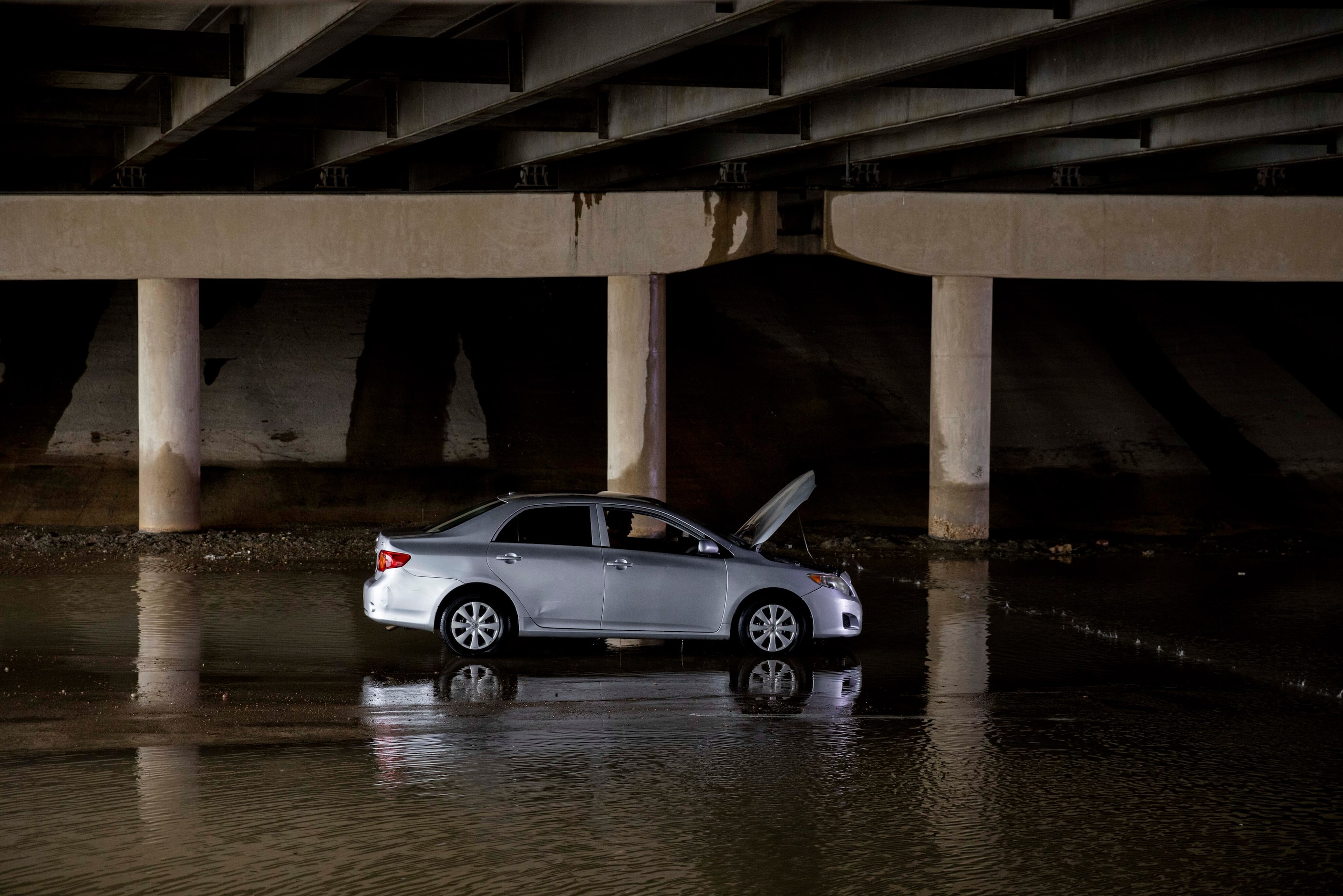 A driver sits in their stalled car on Military Parkway under Interstate 635 on Monday, Aug....