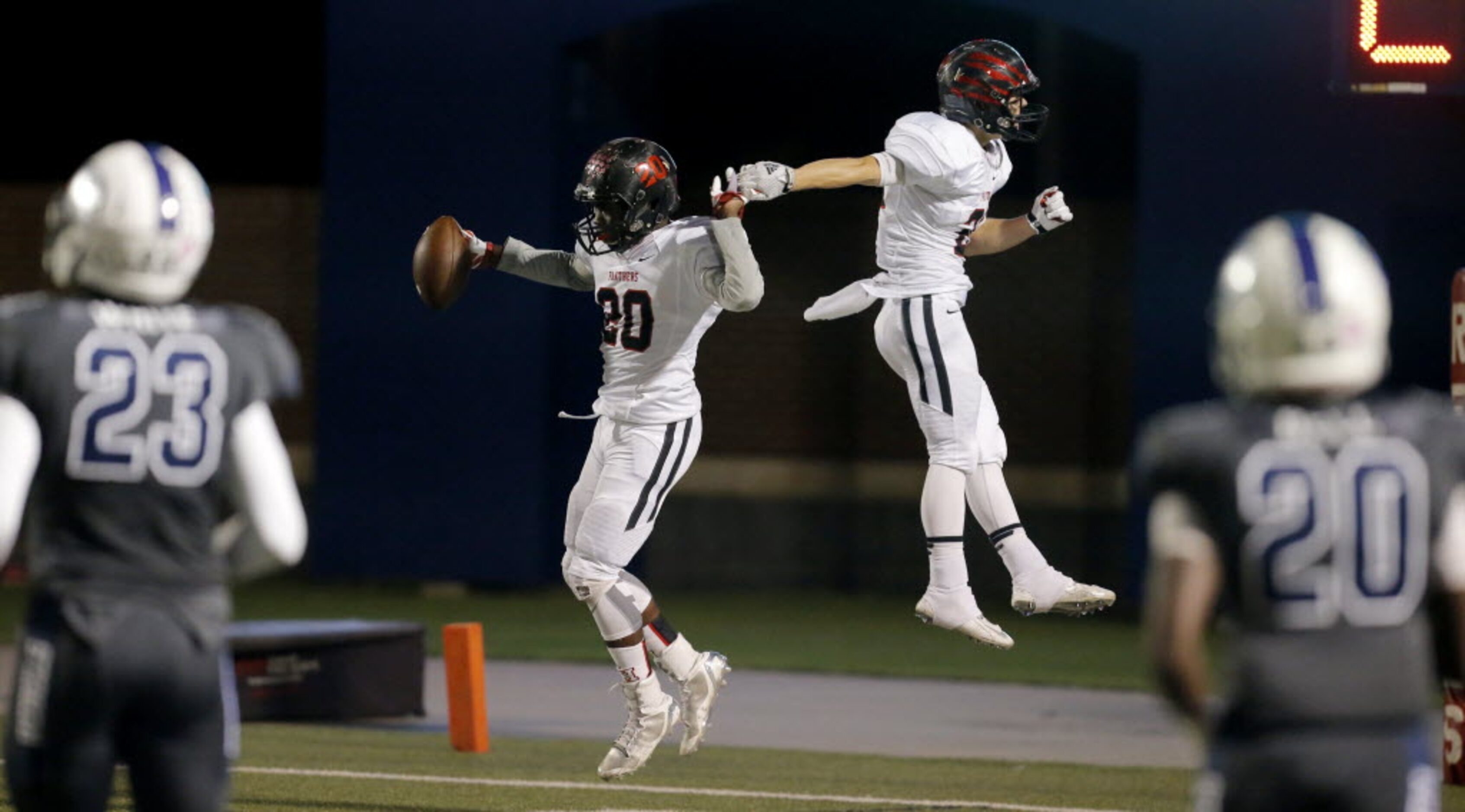 Colleyville Heritage sophomore wide receiver Ke'von Ahmad, left, is congratulated by junior...