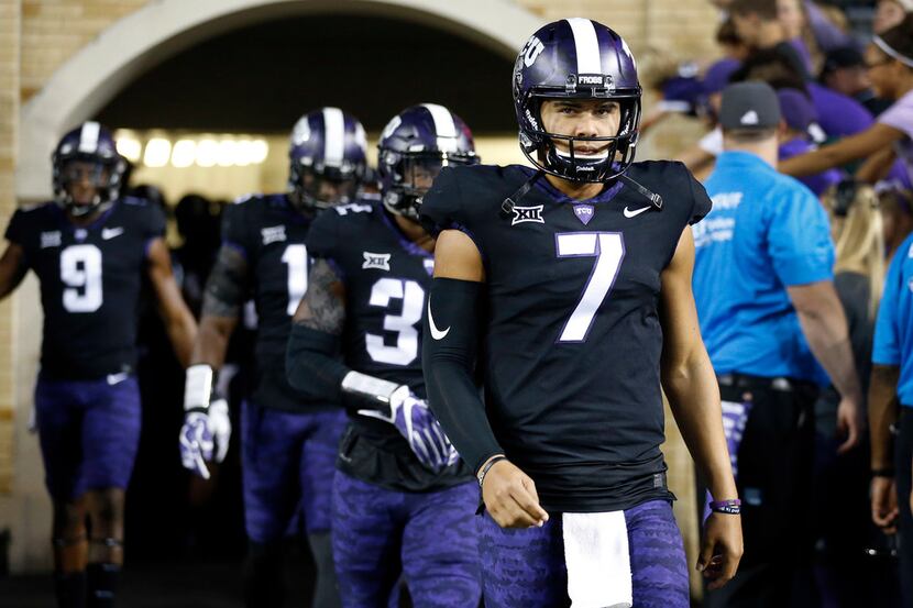 TCU Horned Frogs quarterback Kenny Hill (7) leads his teammates onto the field before facing...