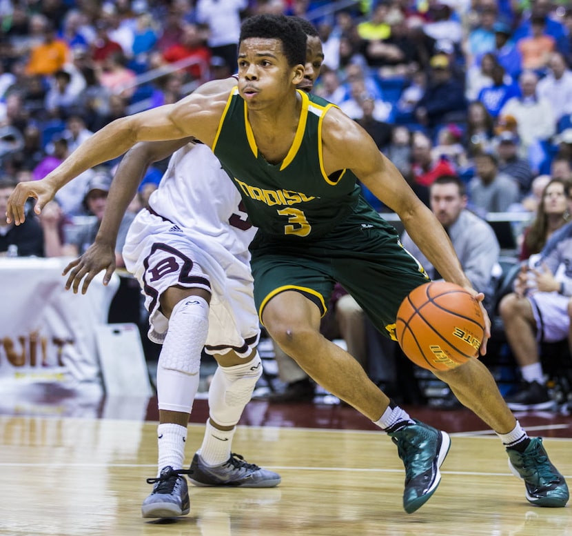 Madison guard Admon Gilder (3) makes his way past Bridgeport guard Keenan Holdman (5) during...