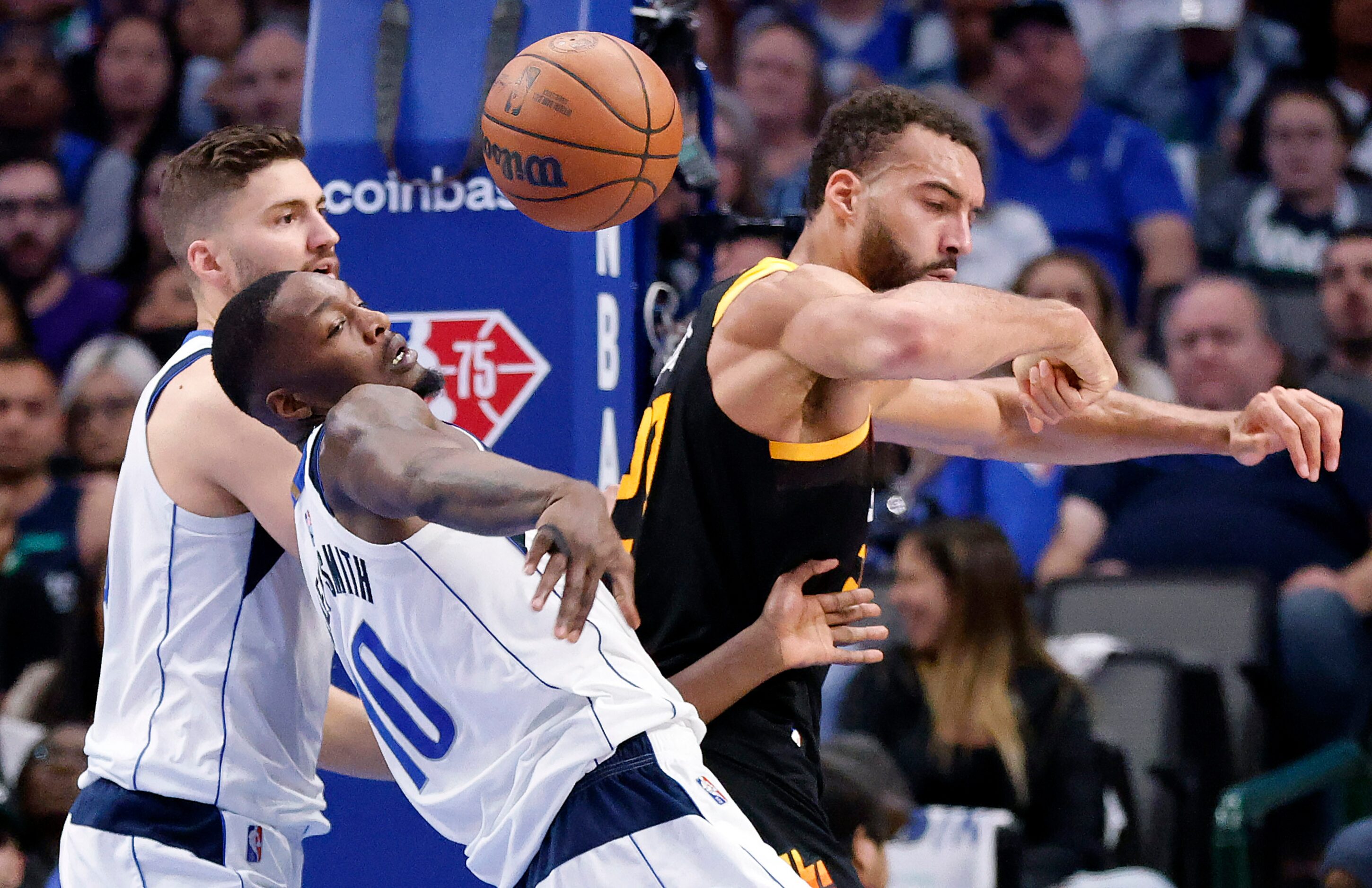 Dallas Mavericks forward Dorian Finney-Smith (10) wrestles the ball away from Utah Jazz...