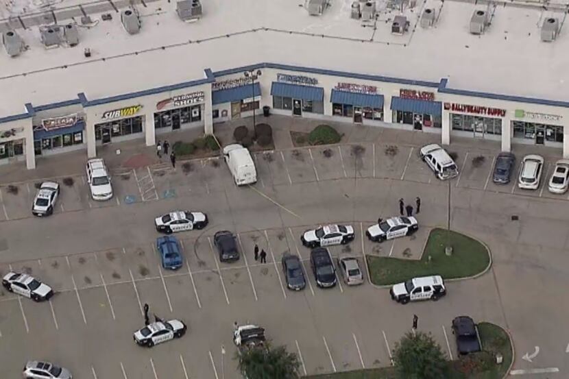 Police at the scene of a fatal shooting outside a credit union in west Oak Cliff on Monday,...