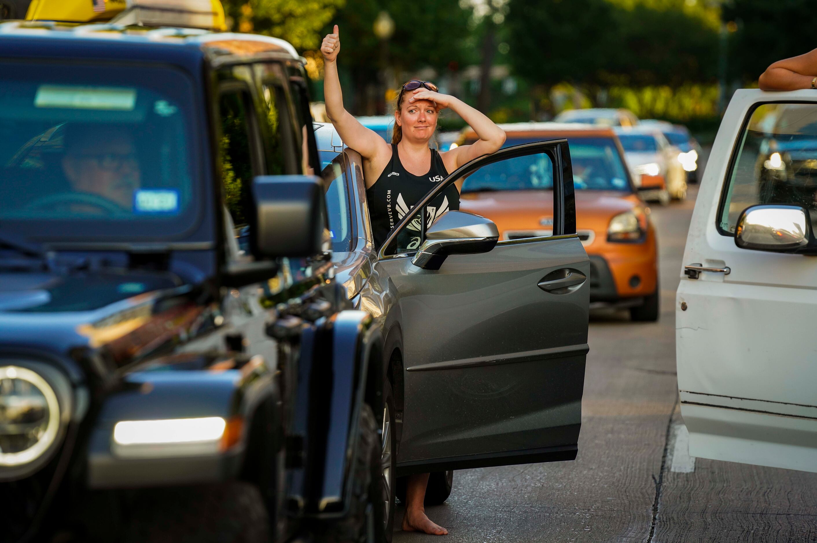 Tori Thompson gets out of her car to show support for protesters blocking the intersection...