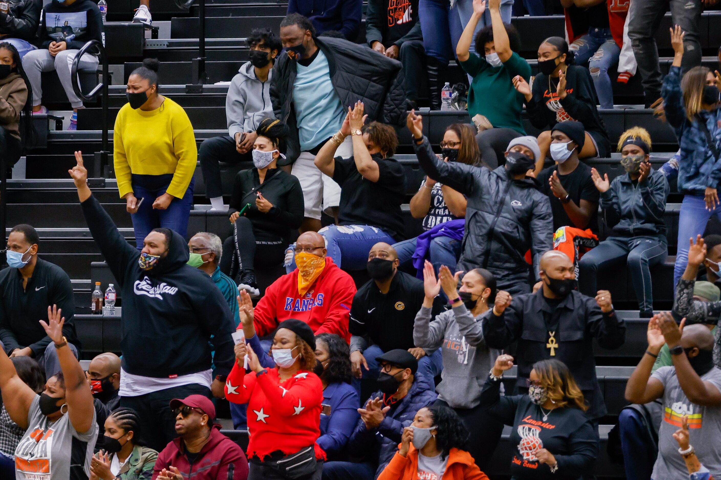 Lancaster fans celebrate during the first half of a boys basketball UIL Class 5A Region II...