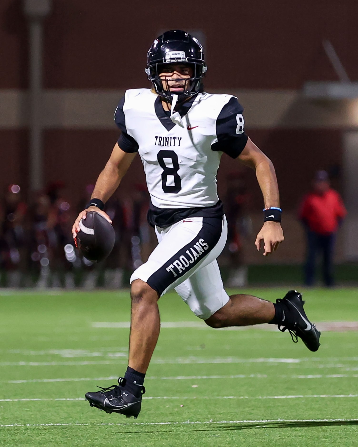 Trinity quarterback TJ Tupou looks for a receiver against Justin Northwest during the first...