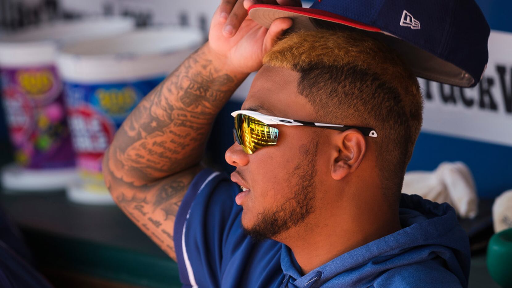 Texas Rangers outfielder Willie Calhoun watches from the dugout before a spring training...