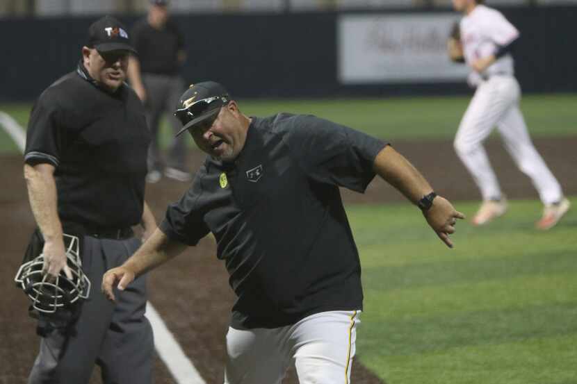 Forney head coach Jason Farrow argues a call with the home plate umpire during seventh...