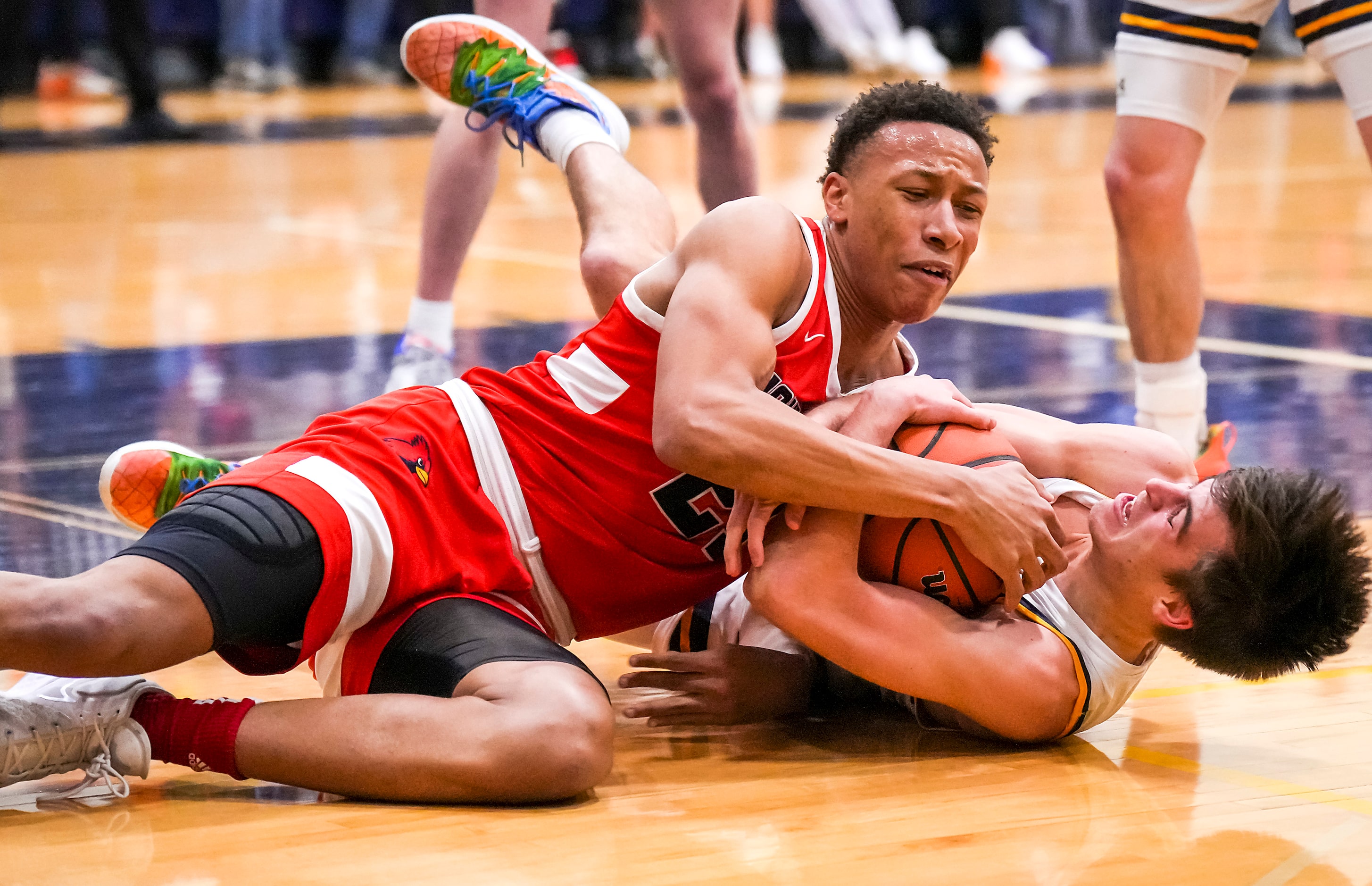 John Paul II's Gabe Warren (21) fights for a loose ball with Prestonwood Christian's Jake...