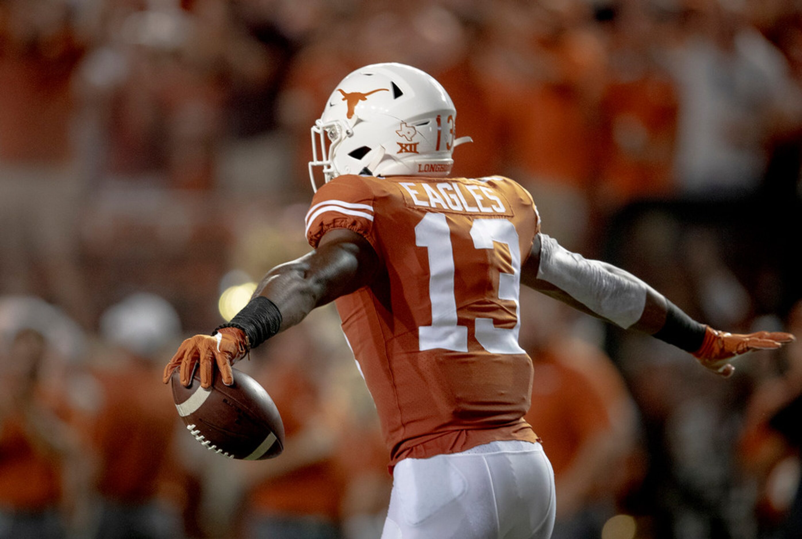 Texas wide receiver Brennan Eagles (13) celebrates a 73-yard touchdown reception against...