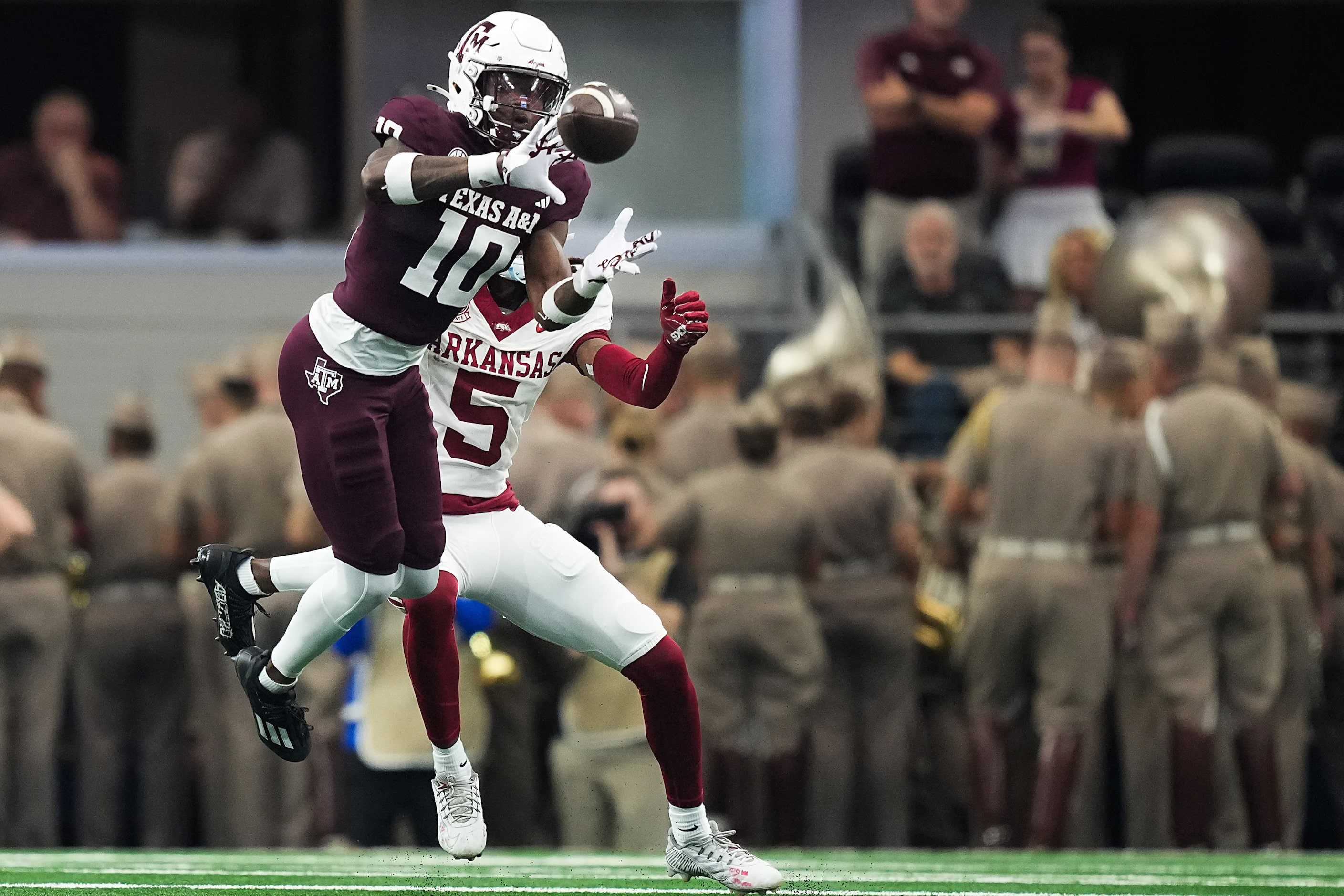 Texas A&M defensive back Dezz Ricks (10) intercepts a pass intended for Arkansas wide...