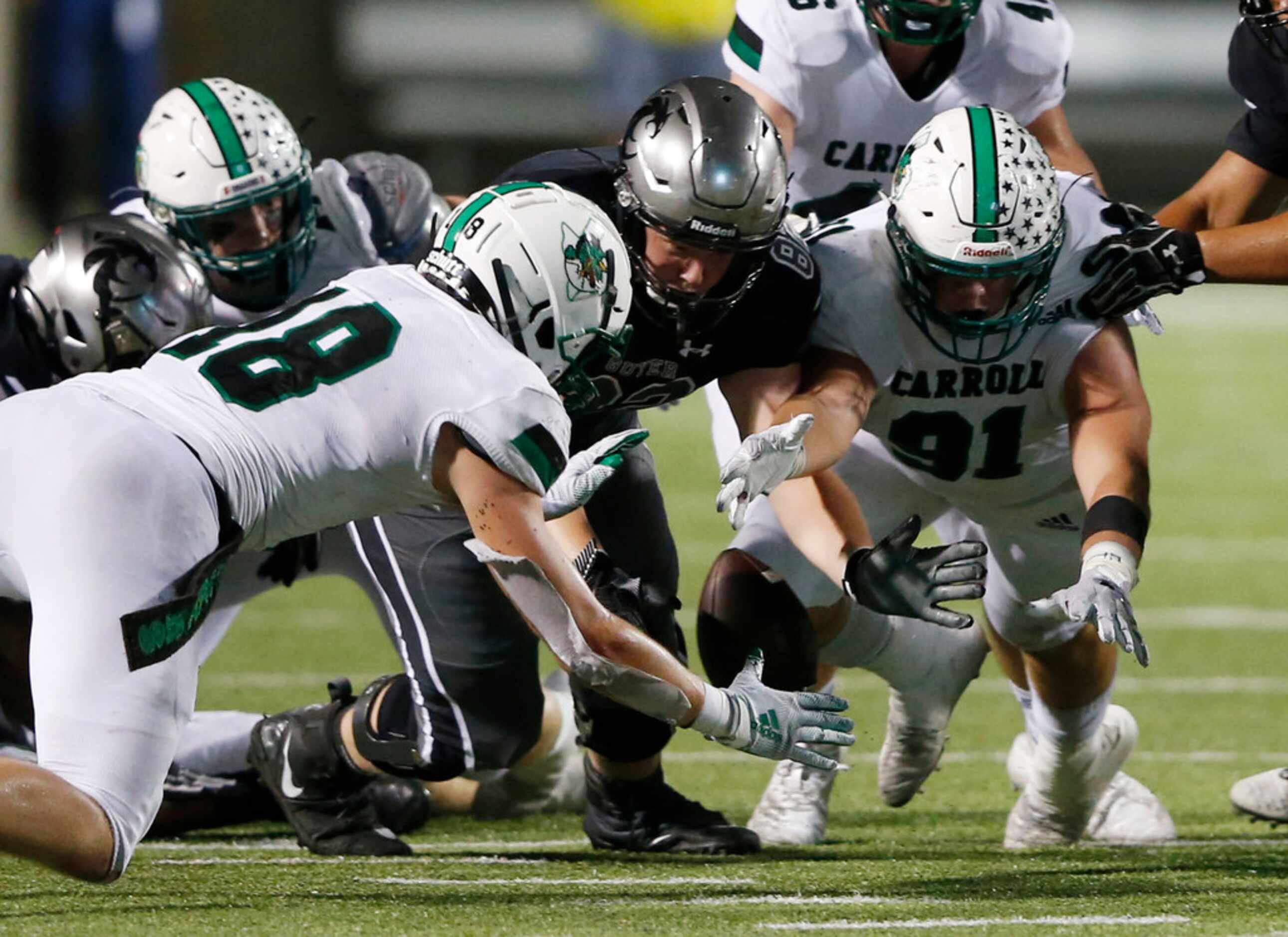 Southlake Carroll's Dillon Springer (91) dives for the fumbled ball and gains possession of...