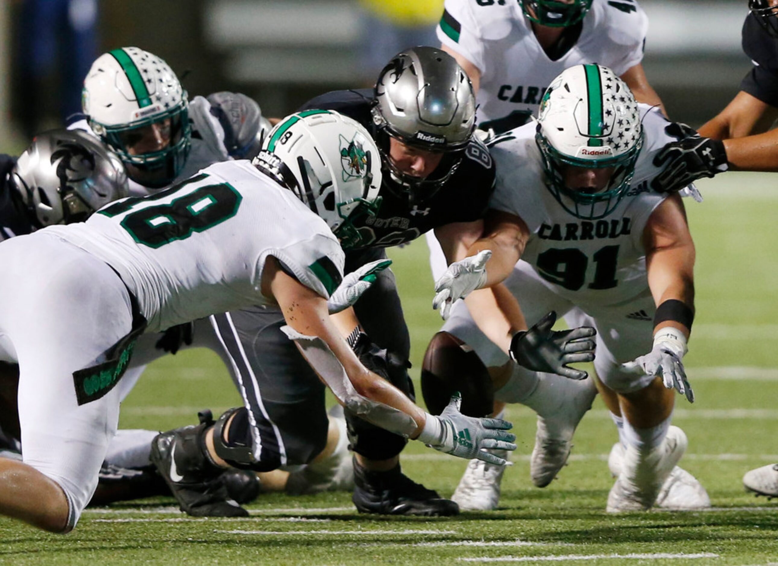 Southlake Carroll's Dillon Springer (91) dives for the fumbled ball and gains possession of...