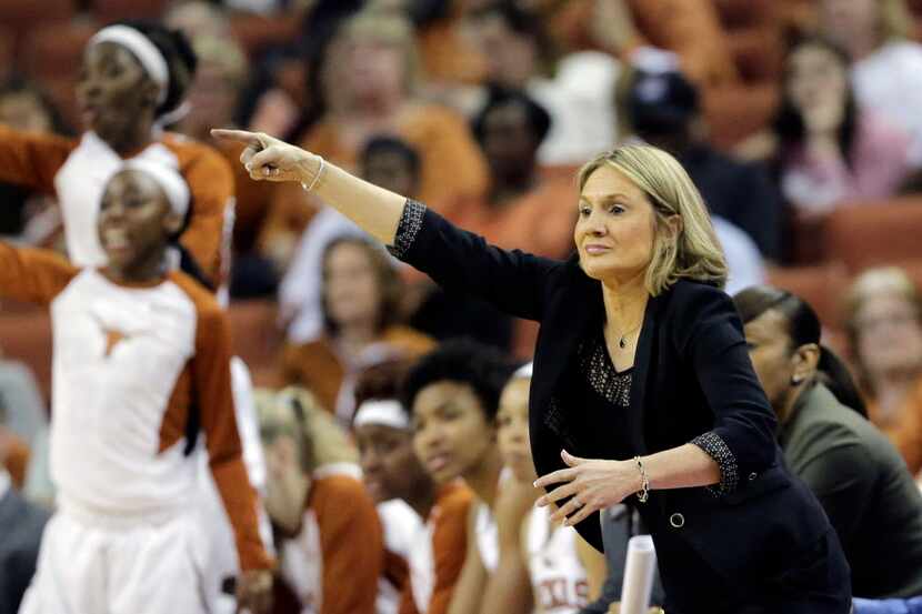 Texas head coach Karen Aston, right, signals to her players during the second half of an...
