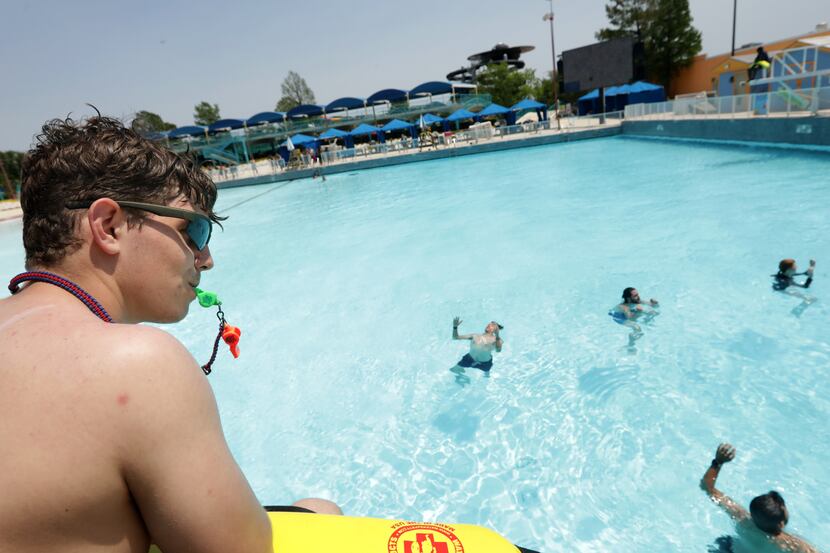 Miles Colvard watches over trainees as they do a swim test during lifeguard training at...