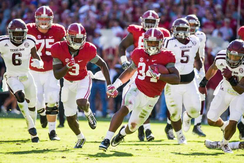 Alabama running back Damien Harris (34) races through the Texas A&M defense during the first...