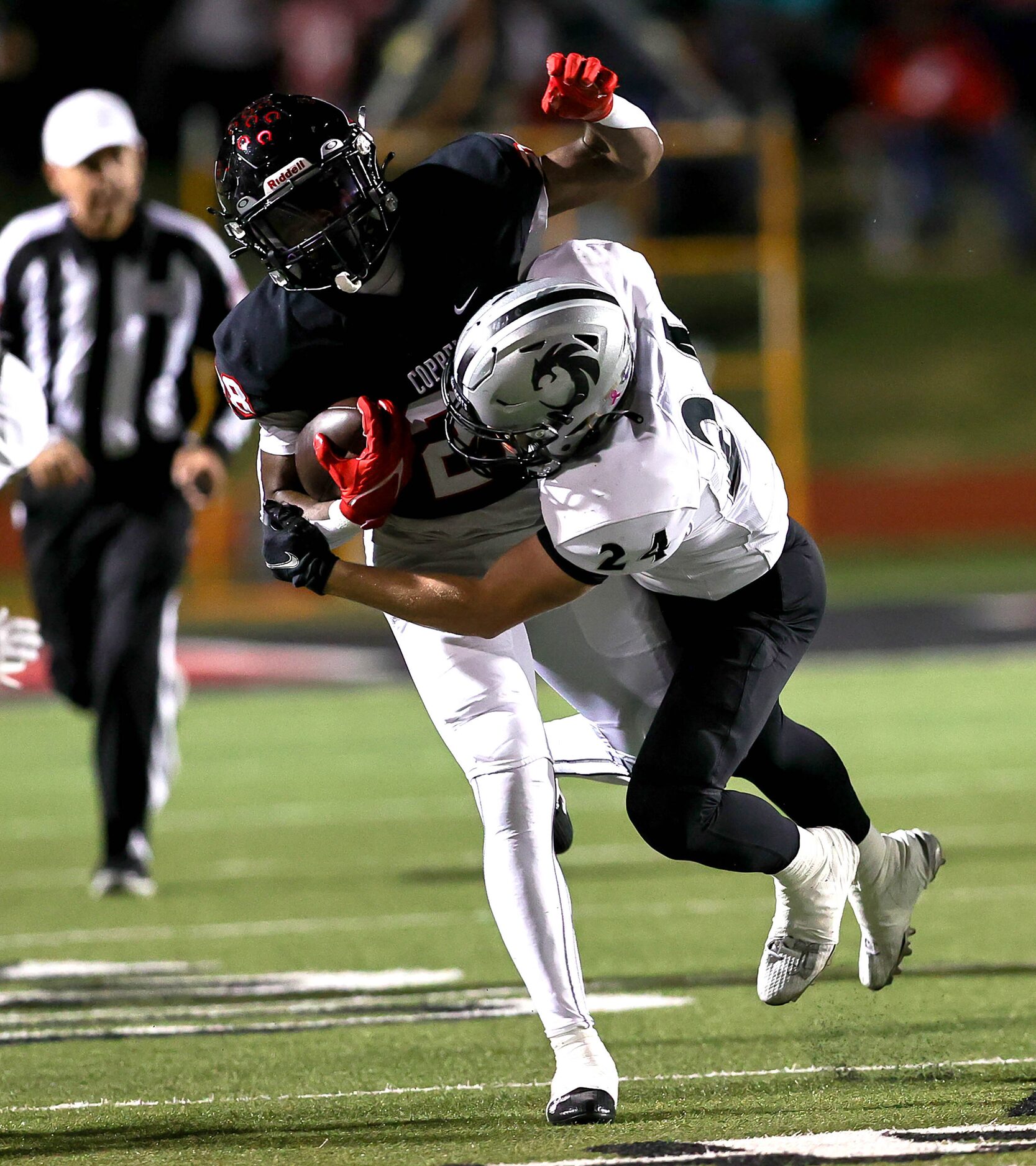 Coppell running back Xavier Mosely (28) stopped by Denton Guyer defensive back Caleb Rowe...