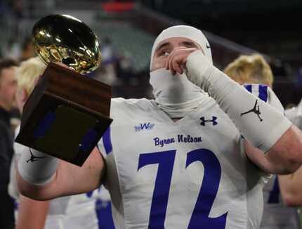 Byron Nelson lineman Abrahim Sakiri (72) soaks in the moment as he holds the regional trophy...