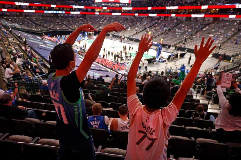 Fans of Dallas Mavericks guard Luka Doncic yell for the tam mascot during a first quarter...