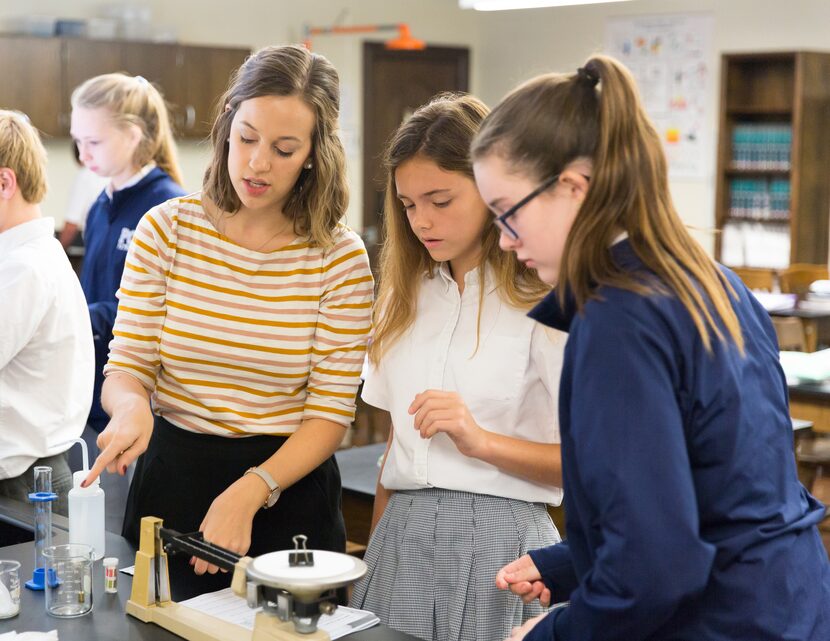 Teacher and Providence Christian School alumna Sarah Thomas (left) leads students in a...