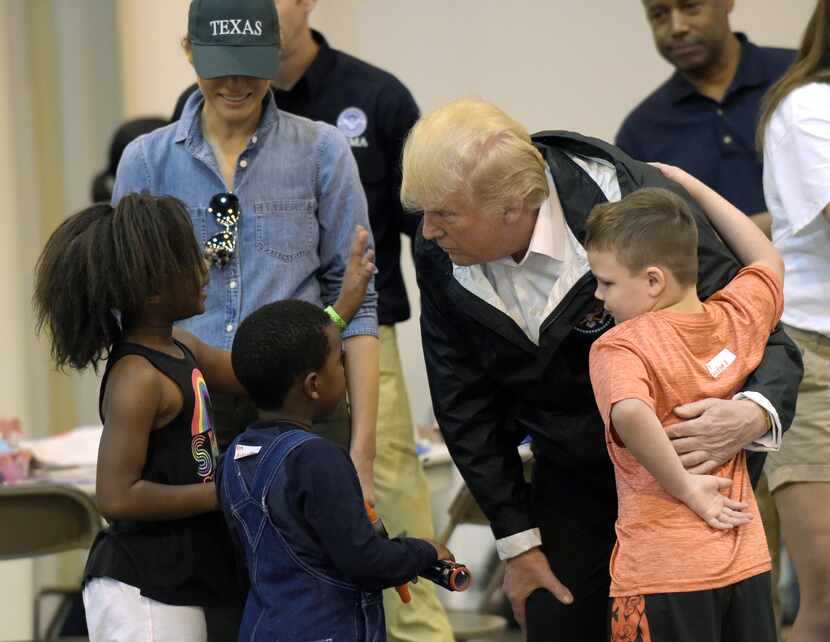 President Donald Trump and his wife, Melania, meet people affected by Hurricane Harvey on...