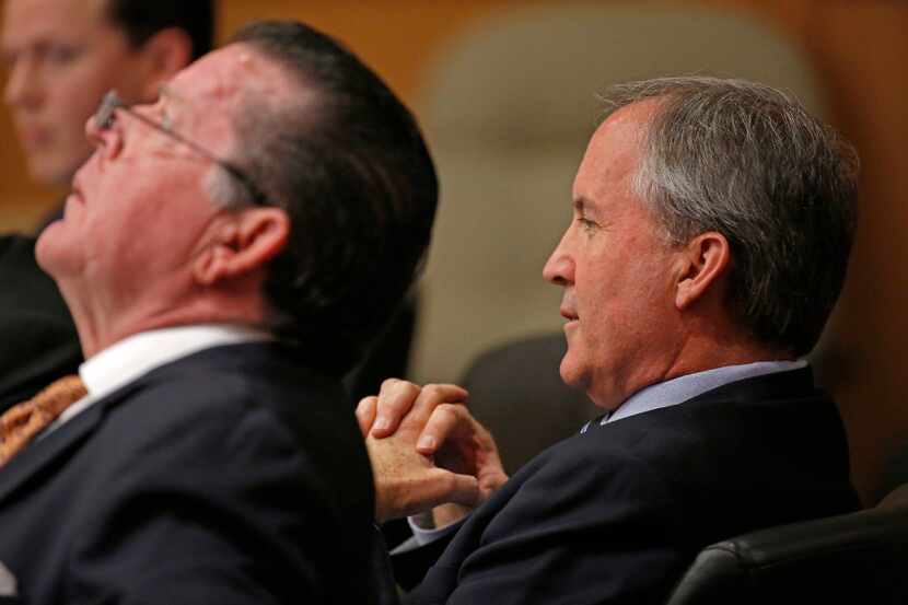 Texas Attorney General Ken Paxton (right) and his attorney Dan Cogdell. (Jae S. Lee/Staff...
