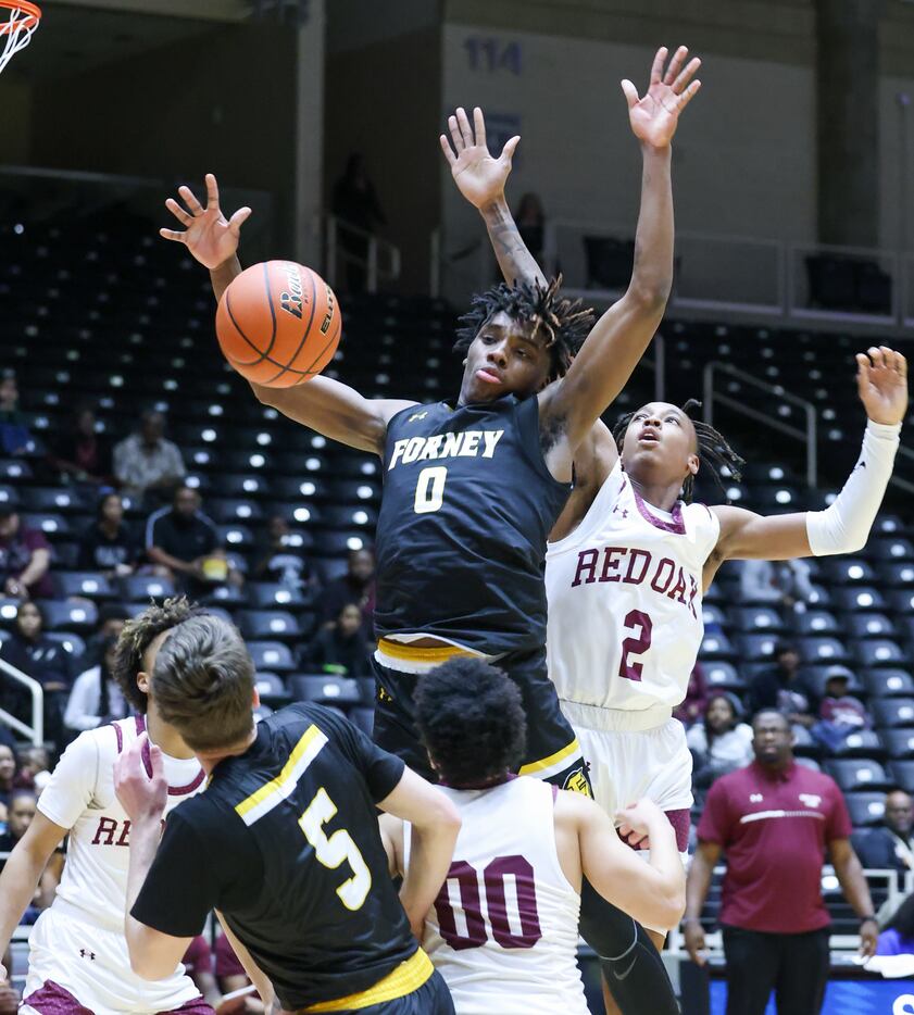 Forney senior forward Ronnie Harrison (0) loses control of the ball mid-jump toward the net,...